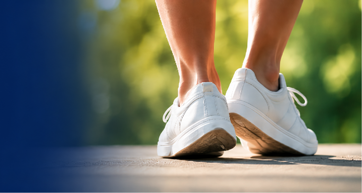 Person walking outdoors in white sneakers